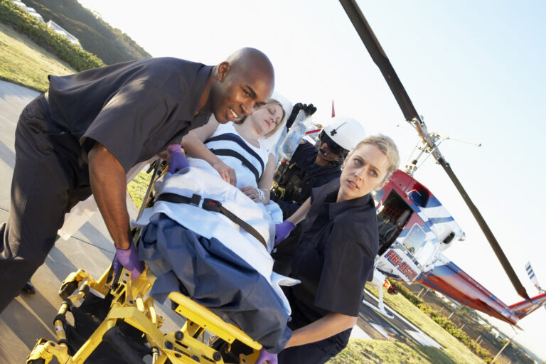 Care flight paramedics take woman out on a stretcher