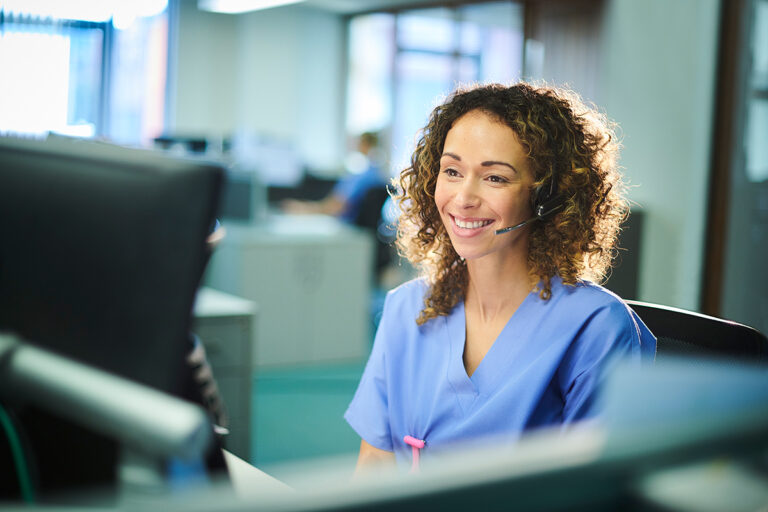 Happy nurse with headset on call