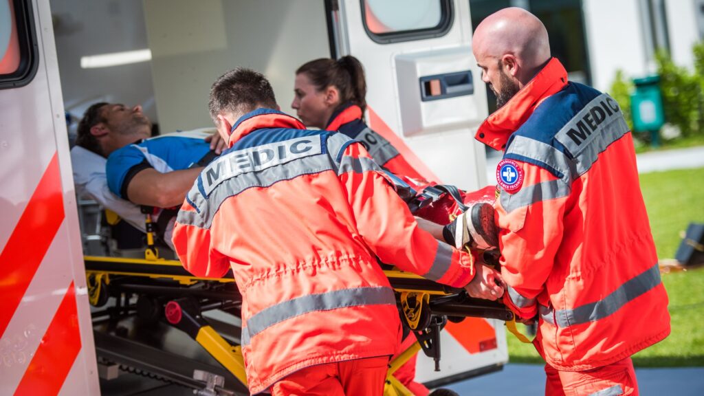 team of paramedics with patient on stretcher