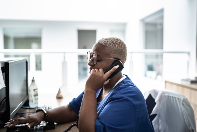 conduit nurse with short hair on phone