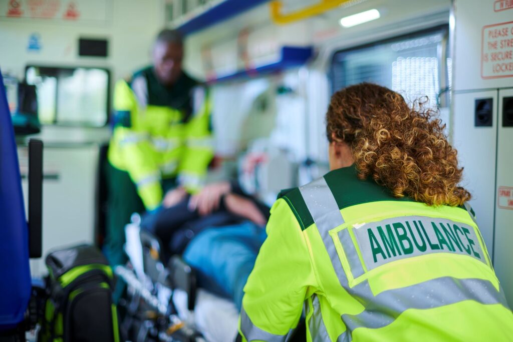 emergency technicians with patients in ambulance