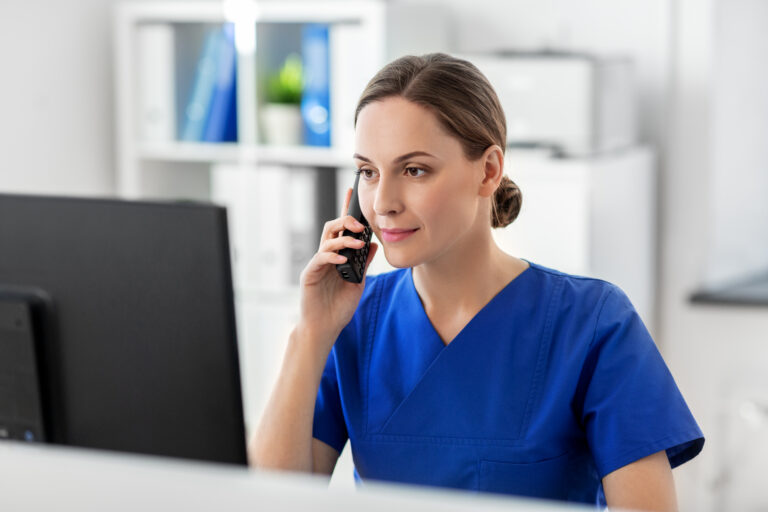 doctor with computer calling on phone at hospital