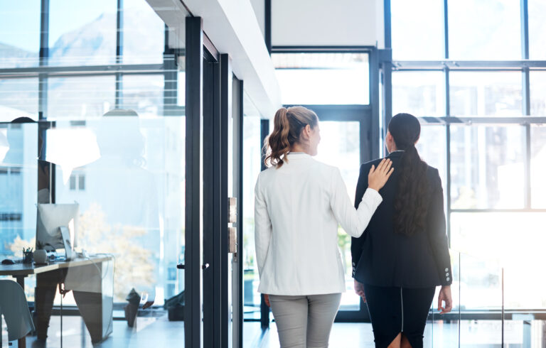 Shot of a businesswoman putting her hand on a colleagues shoulder in a modern office