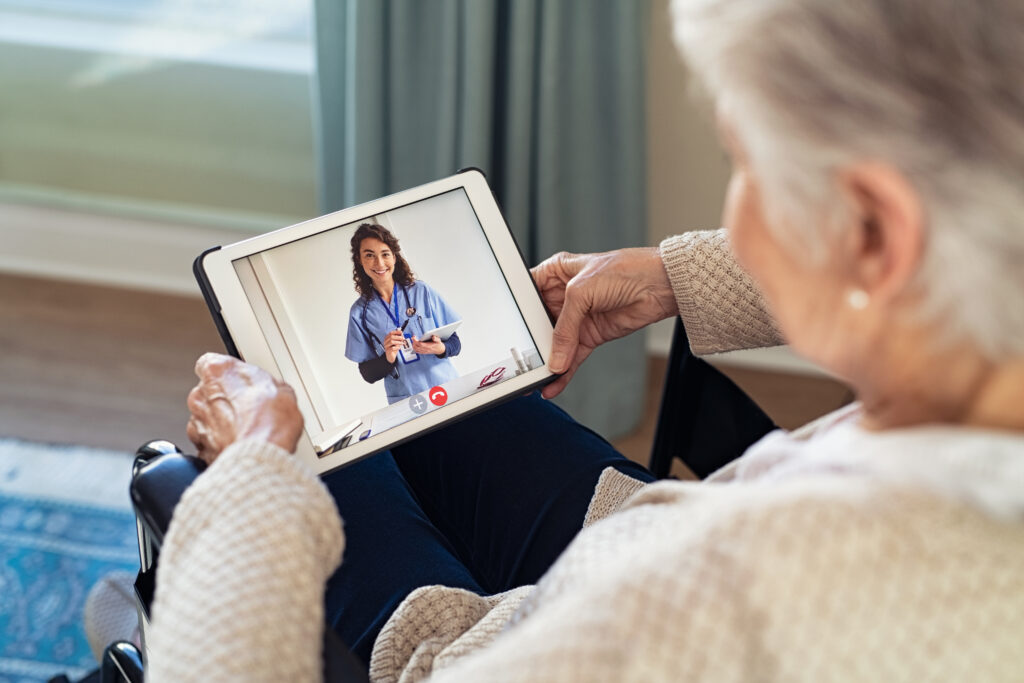 Doctor on video call with disabled senior patient