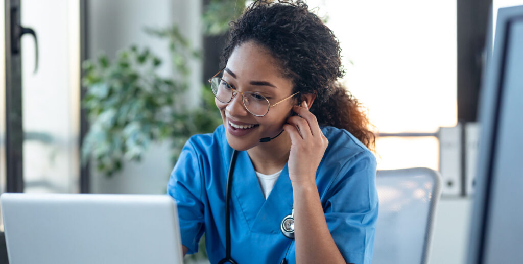 female doctor talking while explaining medical treatment to patient through a video call with laptop in the consultation.