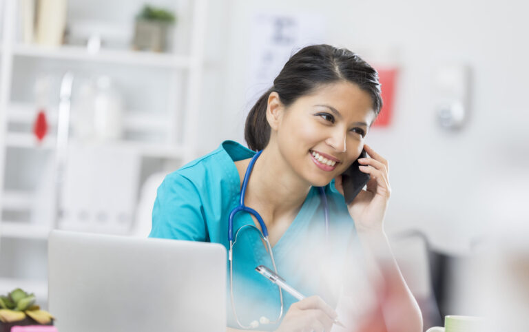 Happy nurse on the phone with a patient