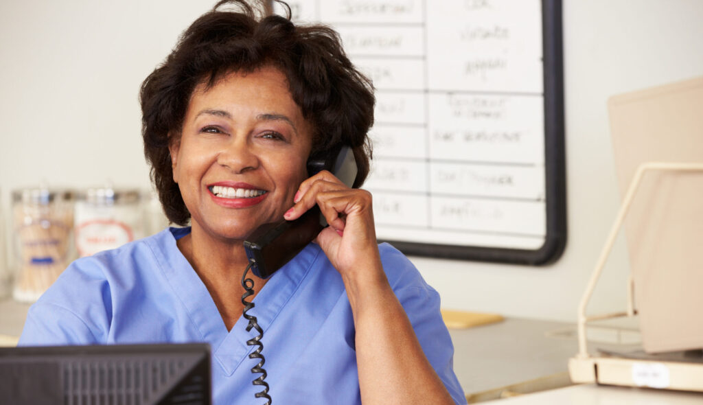 Nurse Making Phone Call At Nurses Station