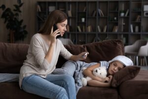 Nervous millennial mom consulting by phone call with pediatrician