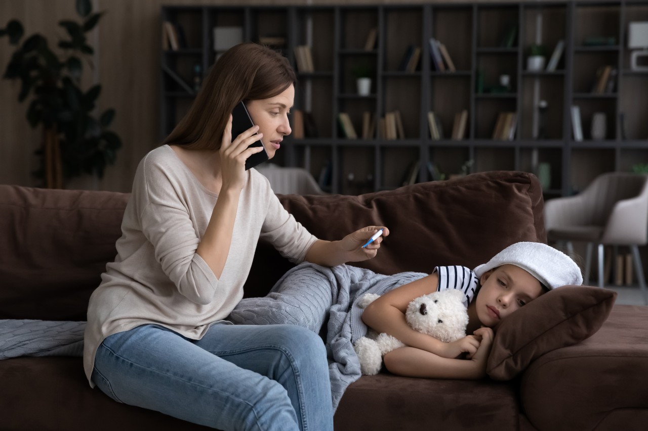 Nervous millennial mom consulting by phone call with pediatrician