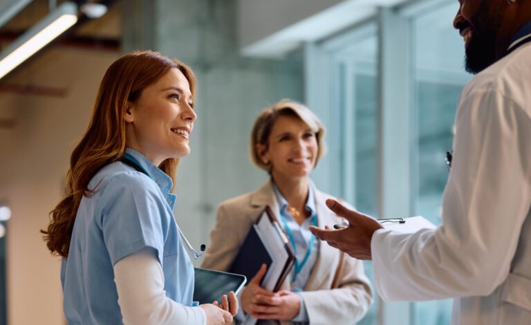 Happy nurse on a meeting with hospital administrator and doctor