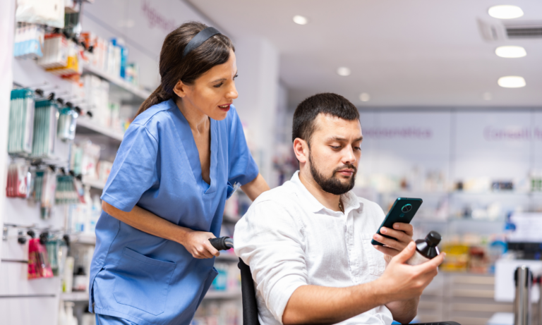 A nurse helps a patient who is being discharged from the hospital to understand his medications.